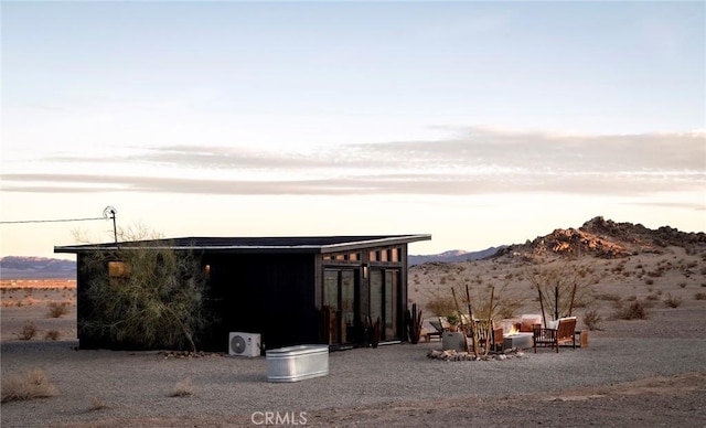 outdoor structure at dusk featuring a mountain view