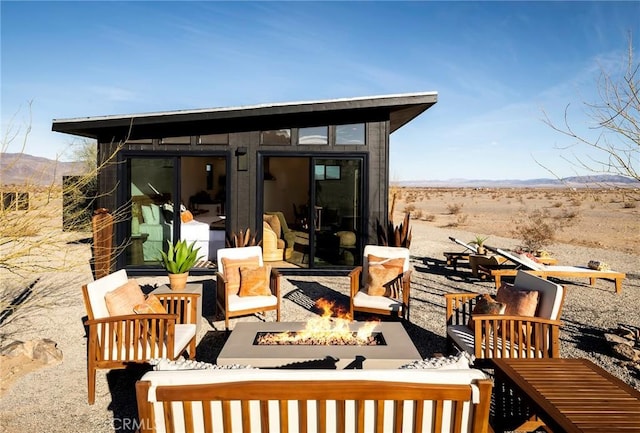 view of outbuilding featuring an outdoor fire pit