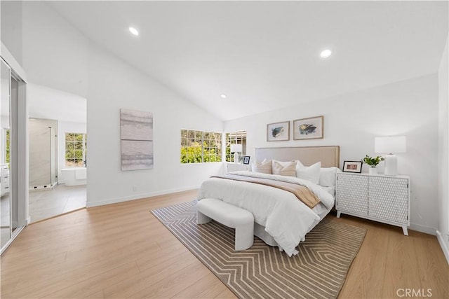 bedroom with high vaulted ceiling, light wood-type flooring, and baseboards