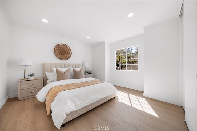 bedroom with light wood-type flooring, baseboards, crown molding, and recessed lighting