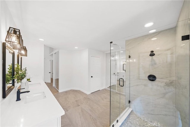 bathroom with double vanity, a stall shower, a sink, and recessed lighting