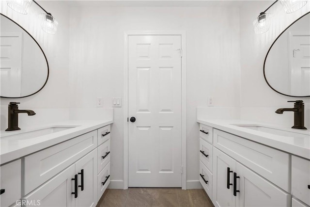 bathroom featuring two vanities and a sink