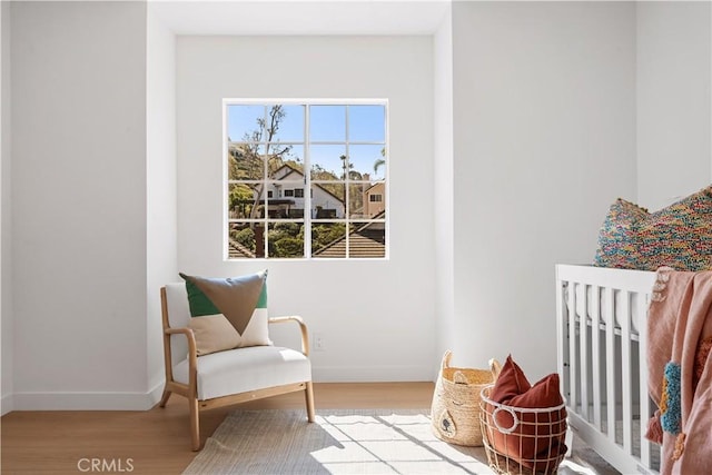 living area with wood finished floors and baseboards