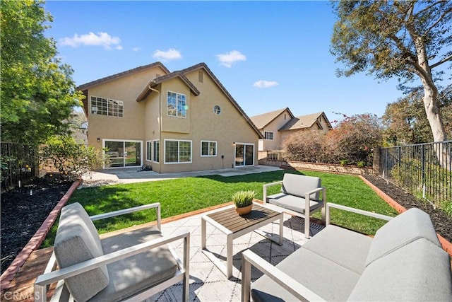 back of house featuring a yard, a patio, stucco siding, a fenced backyard, and an outdoor living space