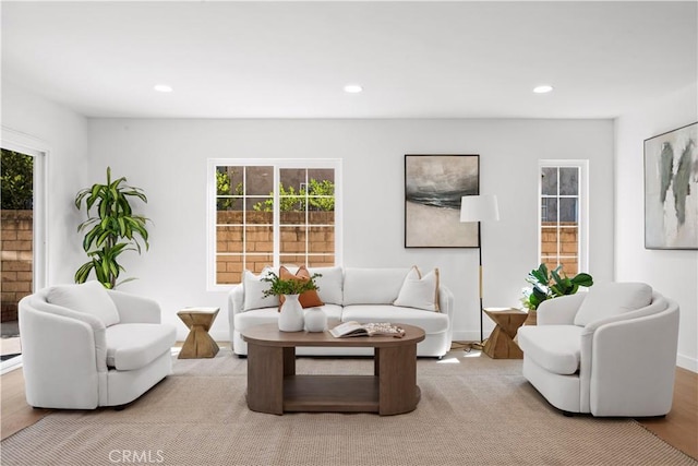 living room featuring a wealth of natural light, wood finished floors, and recessed lighting