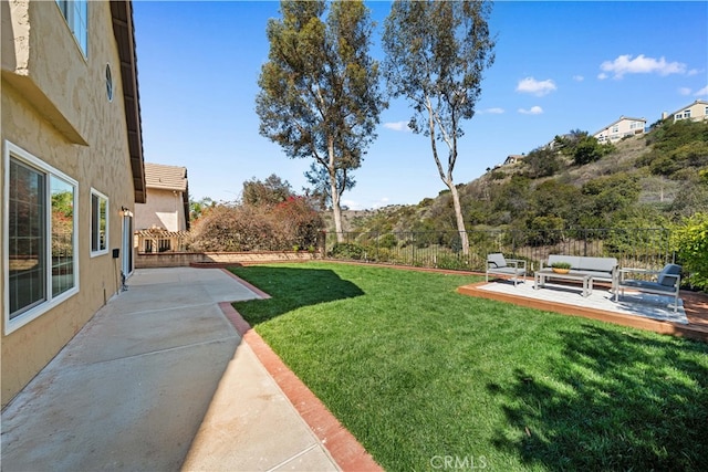 view of yard with a patio area, a fenced backyard, and an outdoor living space