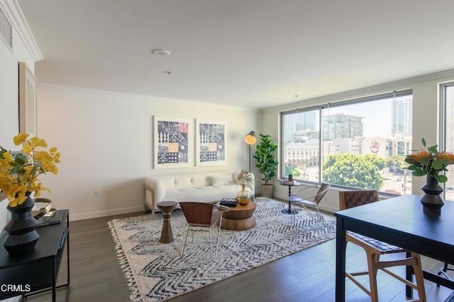 living area featuring dark wood-style floors, visible vents, baseboards, ornamental molding, and a city view