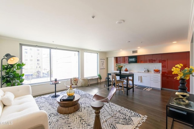 living room with visible vents, recessed lighting, crown molding, baseboards, and dark wood-style flooring