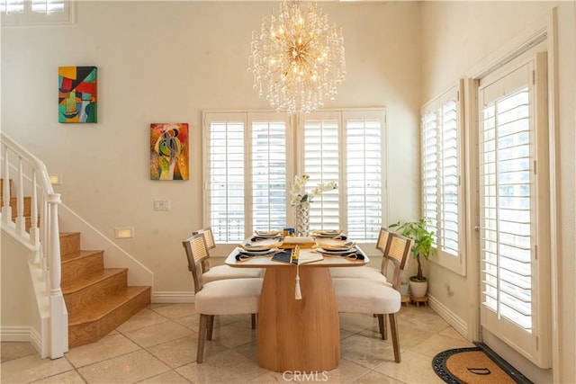 dining space with an inviting chandelier, baseboards, stairway, and light tile patterned flooring