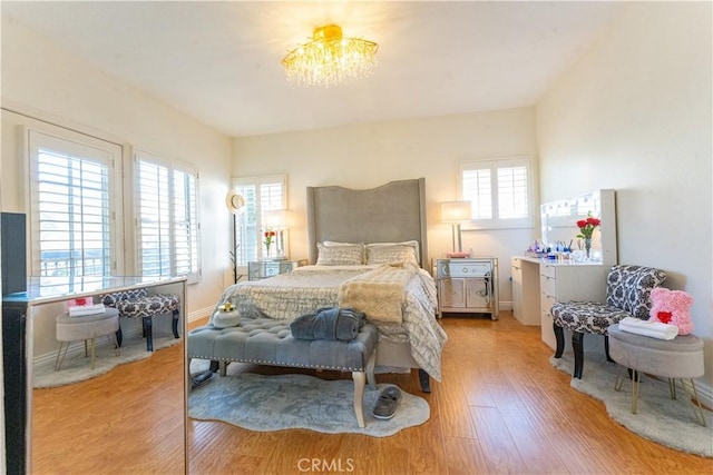 bedroom with light wood-style floors and baseboards