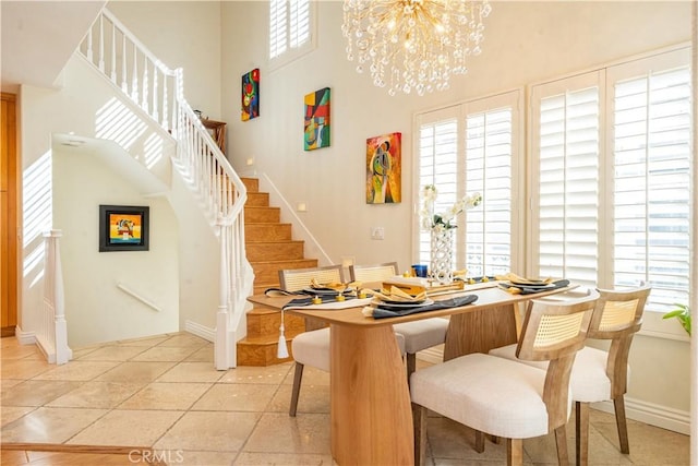 dining room featuring an inviting chandelier, plenty of natural light, stairway, and light tile patterned flooring