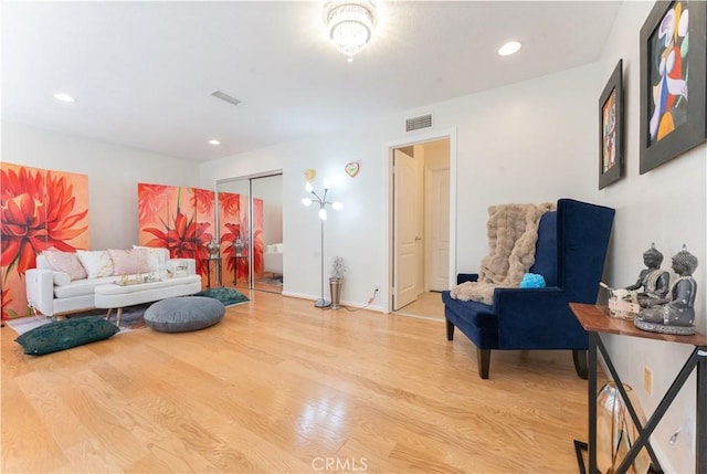 living room with recessed lighting, visible vents, and light wood-style floors