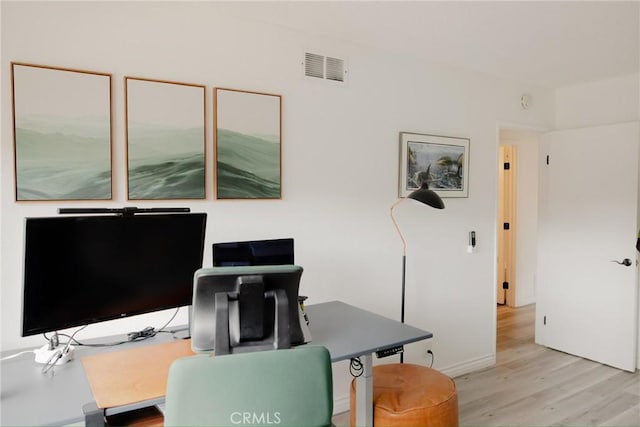 office area featuring light wood-style floors and visible vents