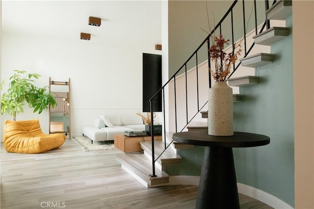 stairs with baseboards and wood finished floors