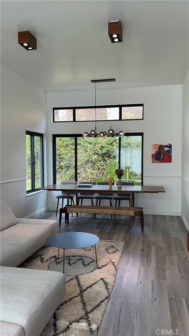 living room with wood-type flooring and baseboards