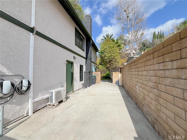 view of property exterior featuring a patio area, a fenced backyard, and stucco siding