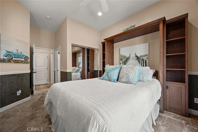 carpeted bedroom with ceiling fan and a closet