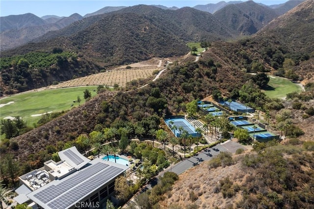 birds eye view of property featuring view of golf course and a mountain view