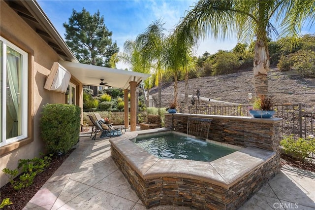 view of patio / terrace with fence and a ceiling fan