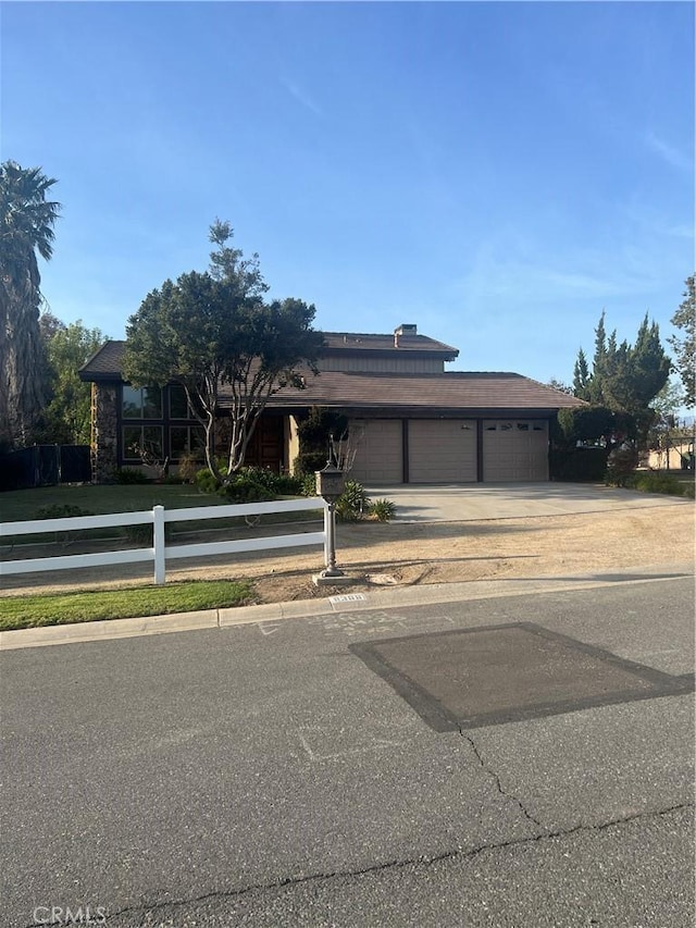 view of front of home featuring concrete driveway and an attached garage