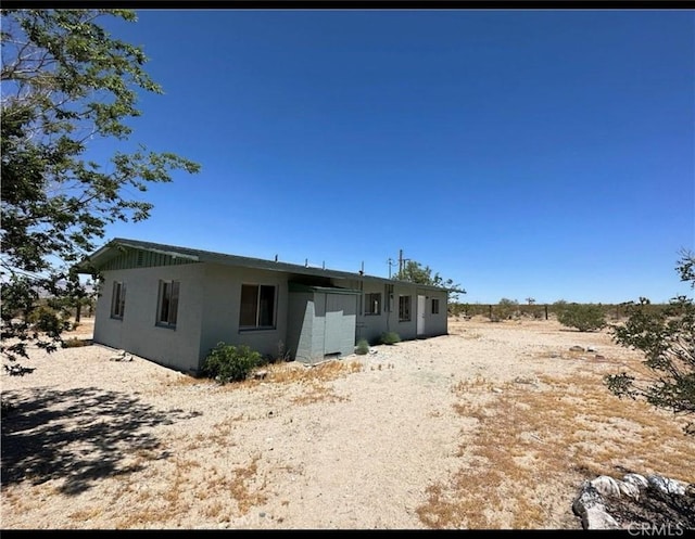 back of house featuring driveway