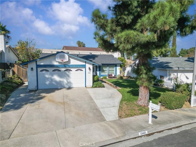 single story home with a garage, a front yard, concrete driveway, and fence