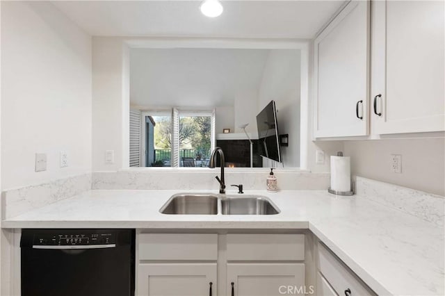 kitchen featuring black dishwasher, white cabinets, and a sink