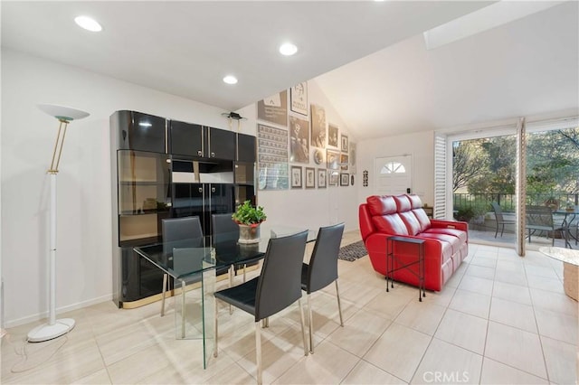 dining room featuring a wealth of natural light, vaulted ceiling, recessed lighting, and tile patterned floors