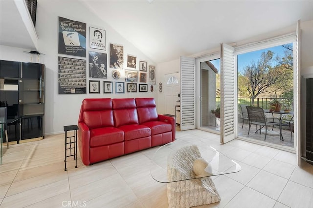 tiled living area featuring high vaulted ceiling