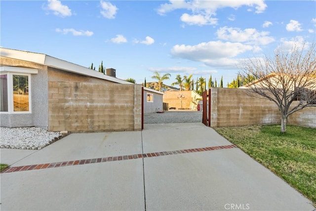 view of gate featuring a patio area and fence