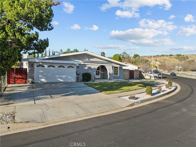 ranch-style house featuring driveway and an attached garage