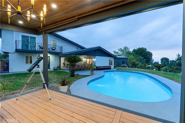 outdoor pool featuring a patio area and a yard