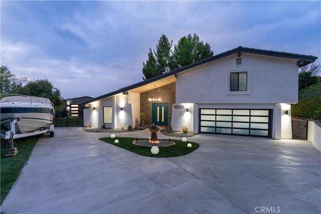 contemporary house with concrete driveway and stucco siding