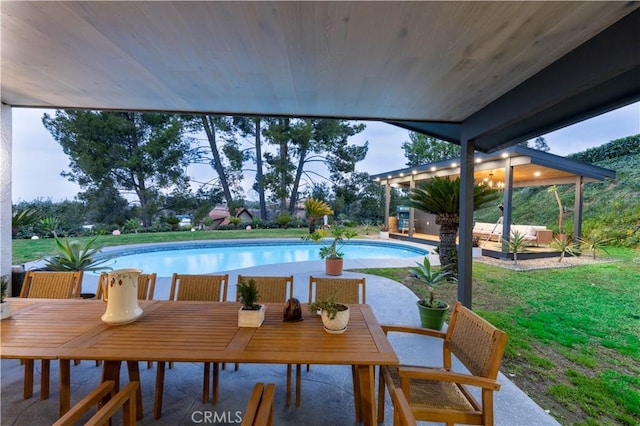 pool featuring a patio and outdoor dining space