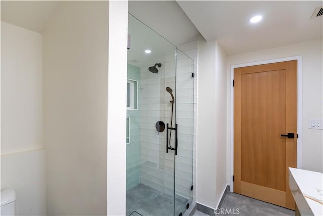 bathroom with toilet, a stall shower, visible vents, and recessed lighting