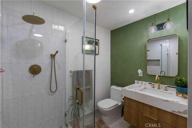 full bath with toilet, a stall shower, vanity, and tile patterned floors