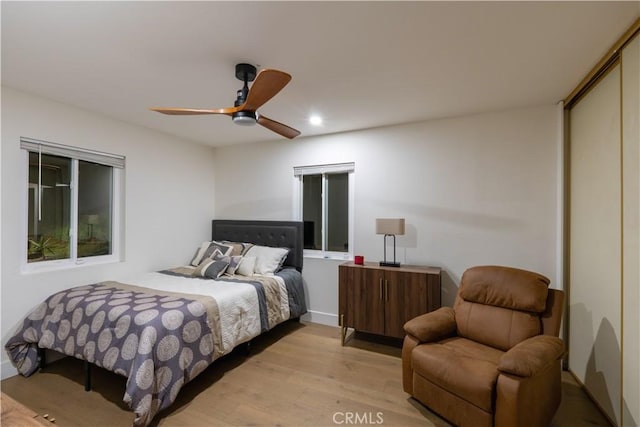 bedroom with a closet, recessed lighting, a ceiling fan, and light wood-style floors