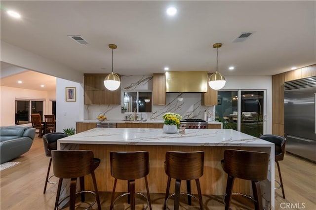 kitchen featuring appliances with stainless steel finishes, visible vents, and tasteful backsplash