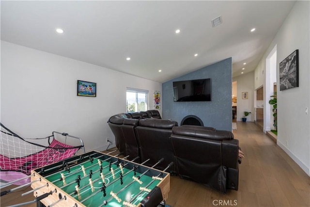 recreation room with recessed lighting, wood finished floors, visible vents, baseboards, and vaulted ceiling