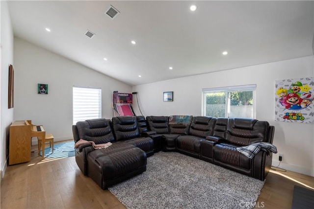 living area with lofted ceiling, light wood-style floors, visible vents, and recessed lighting