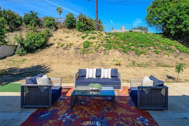 view of patio featuring outdoor lounge area and fence