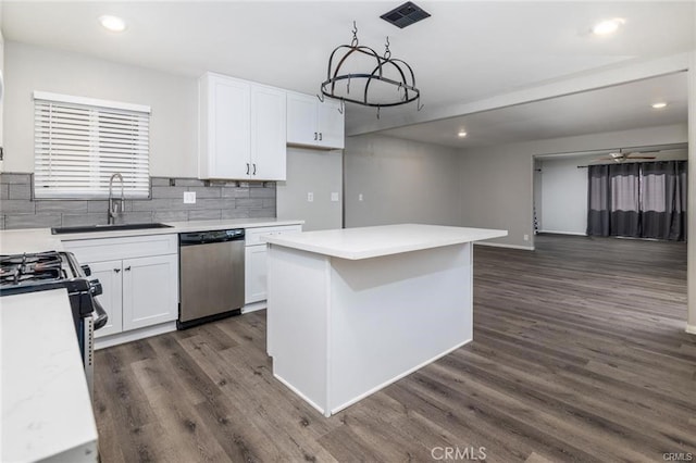 kitchen with dishwasher, light countertops, a sink, and white cabinetry