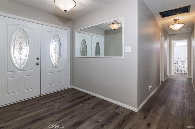 foyer entrance with dark wood-style flooring, visible vents, french doors, and baseboards