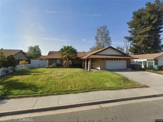 ranch-style house with brick siding, an attached garage, fence, driveway, and a front lawn