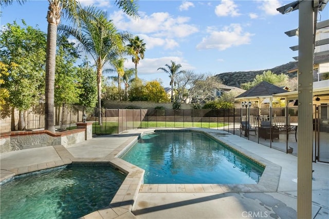 view of pool featuring a fenced in pool, a patio area, a fenced backyard, and a mountain view