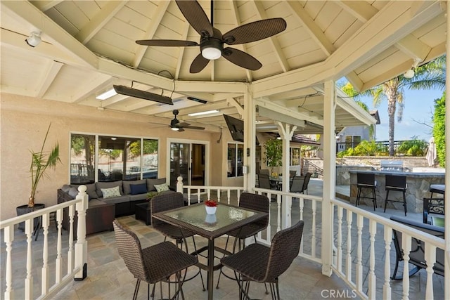 sunroom / solarium with lofted ceiling with beams, plenty of natural light, and wooden ceiling