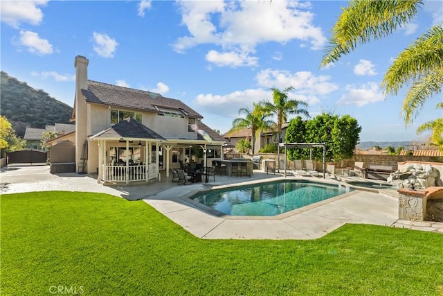 view of swimming pool with a fenced in pool, a patio area, a lawn, and fence