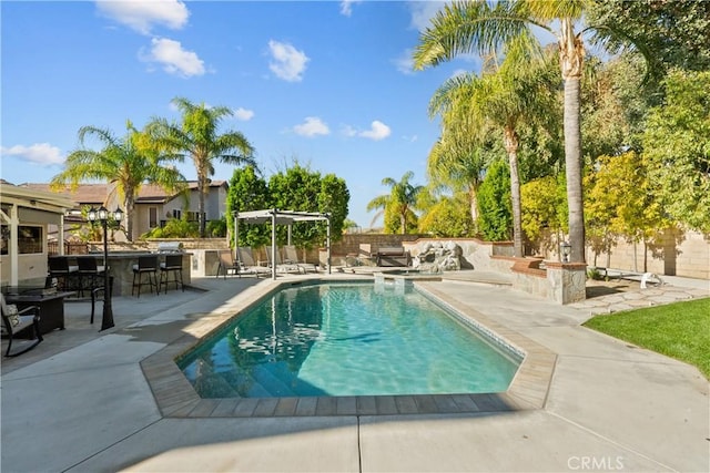 view of pool featuring outdoor dry bar, a patio, a fenced in pool, and a pergola