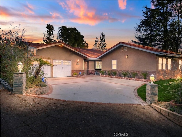 5386 Harter Ln, La Canada Flintridge, CA 91011 - view of front of property featuring stucco siding, driveway, and an attached garage