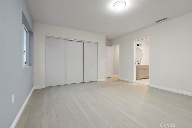 5386 Harter Ln, La Canada Flintridge, CA 91011 - unfurnished bedroom featuring a closet, light wood-type flooring, baseboards, and connected bathroom